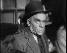 Scene from the Film The Informer': Male Actor Looking at Money Being Thrown on the..., 1920s. Creator: British Pathe Ltd