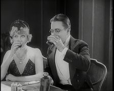 Scene from the Film A Little Bit of Fluff': The Female Actor Betty Balfour Sitting at a ..., 1920s. Creator: British Pathe Ltd