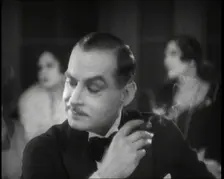Scene from the Film Champagne': a Male Actor in a Nightclub Smoking a Cigarette, 1920s. Creator: British Pathe Ltd