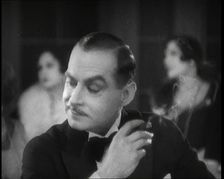 Scene from the Film Champagne': a Male Actor in a Nightclub Smoking a Cigarette, 1920s. Creator: British Pathe Ltd