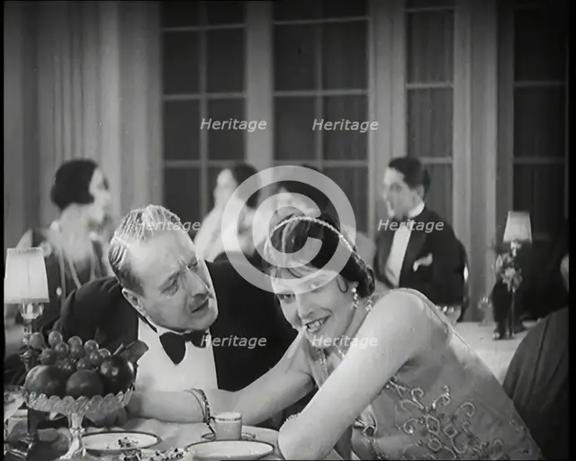 Scene from the Film 'Champagne': Two Actors Sitting at a Table in a Nightclub, 1920s. Creator: British Pathe Ltd.