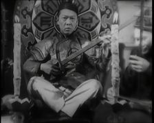 Scene from the Film Piccadilly': Male Actor Playing a Lute, 1920s. Creator: British Pathe Ltd