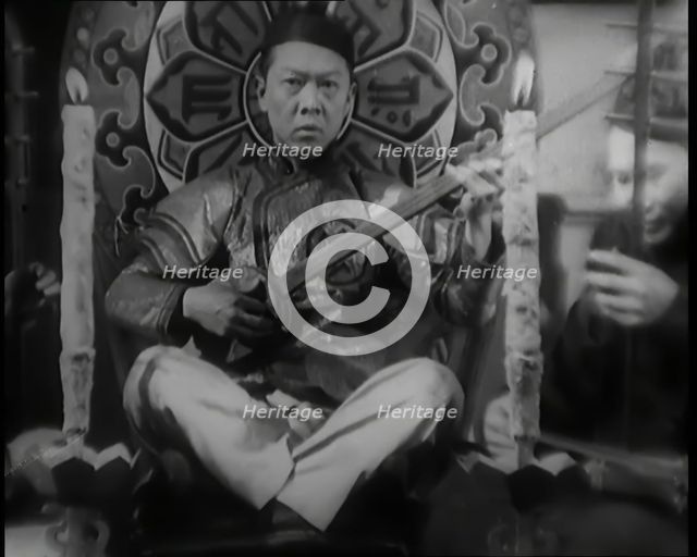 Scene from the Film 'Piccadilly': Male Actor Playing a Lute, 1920s. Creator: British Pathe Ltd.