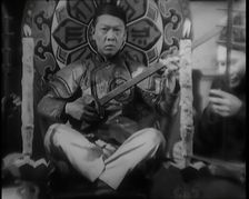 Scene from the Film Piccadilly': Male Actor Playing a Lute, 1920s. Creator: British Pathe Ltd