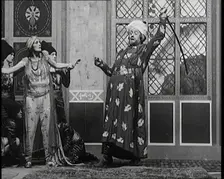 Scene from the Play Hassan': the Actor Henry Ainley in Full Costume Raising a Sword..., 1920s. Creator: British Pathe Ltd