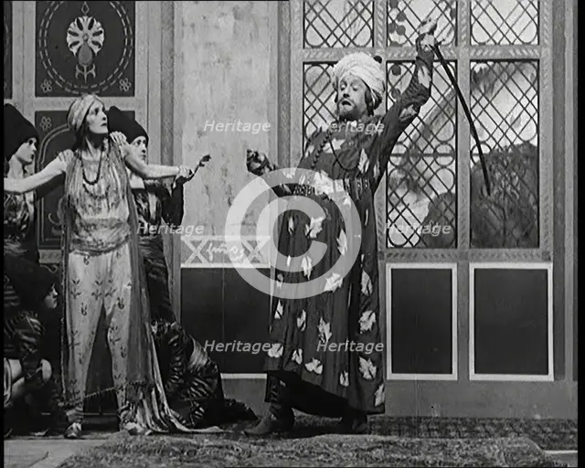 Scene from the Play 'Hassan': the Actor Henry Ainley in Full Costume Raising a Sword..., 1920s. Creator: British Pathe Ltd.