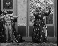 Scene from the Play Hassan': the Actor Henry Ainley in Full Costume Raising a Sword..., 1920s. Creator: British Pathe Ltd