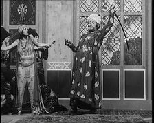 Scene from the Play Hassan': the Actor Henry Ainley in Full Costume Raising a Sword..., 1920s. Creator: British Pathe Ltd