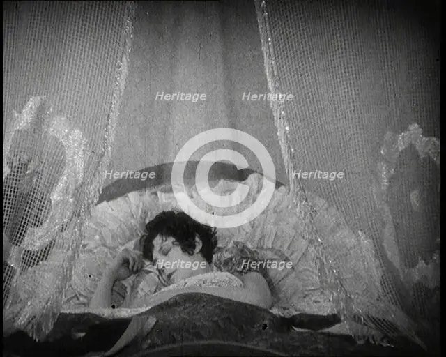 Scene from a 1920s Film. A Female Actor Sleeping in a Bed, 1920s. Creator: British Pathe Ltd.