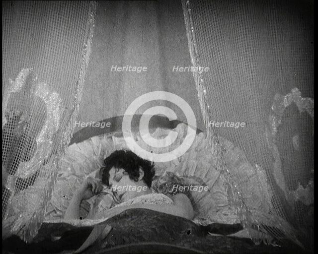 Scene from a 1920s Film. A Female Actor Sleeping in a Bed, 1920s. Creator: British Pathe Ltd.