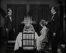 Scene from a 1920s Film. A Group of Actors Playing an Upper Class Family Sitting Down at..., 1920s. Creator: British Pathe Ltd