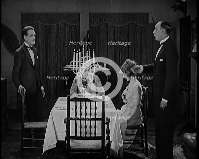 Scene from a 1920s Film. A Group of Actors Playing an Upper Class Family Sitting Down at..., 1920s. Creator: British Pathe Ltd.