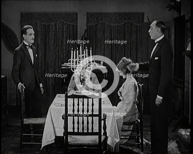 Scene from a 1920s Film. A Group of Actors Playing an Upper Class Family Sitting Down at..., 1920s. Creator: British Pathe Ltd.