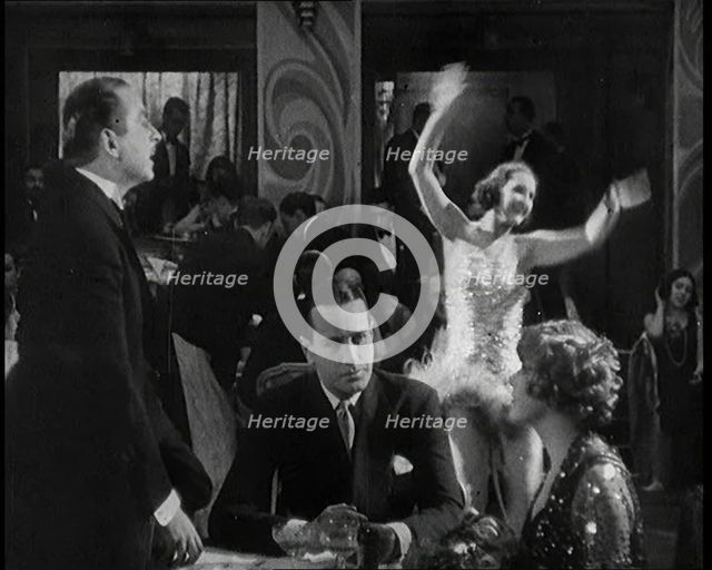 Scene from a 1920s Film. Two Actors Portraying a Couple in a Night Club Scene Whilst a Band...,1920s Creator: British Pathe Ltd.
