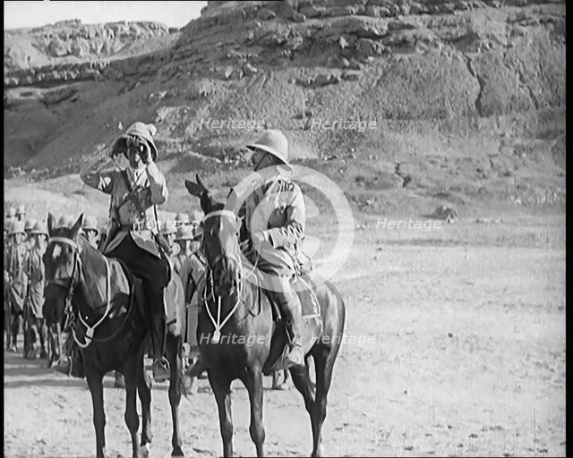 Scene from a Film: a Male Actor Playing a British Soldier on Horseback Looking Through..., 1920s. Creator: British Pathe Ltd.
