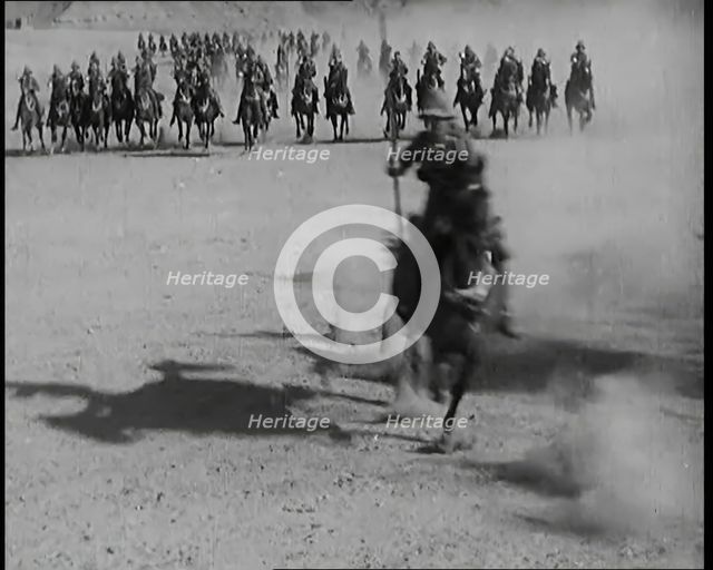 Scene from a Film: Actors Playing British Troops on Horseback Speeding Across a Desert..., 1920s. Creator: British Pathe Ltd.