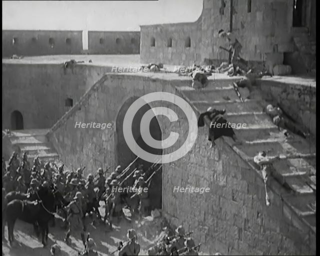 Scene from a Film: Actors Playing British Troops Storming a Fortress Whilst the Dead and..., 1920s. Creator: British Pathe Ltd.