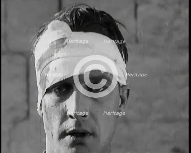 Scene from a Film: Male Actor Playing a Survivor from the Battle Being Questioned..., 1920s. Creator: British Pathe Ltd.