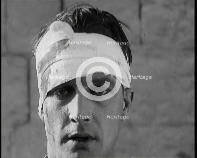 Scene from a Film: Male Actor Playing a Survivor from the Battle Being Questioned..., 1920s. Creator: British Pathe Ltd.