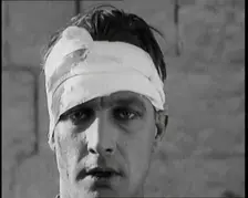 Scene from a Film: Male Actor Playing a Survivor from the Battle Being Questioned..., 1920s. Creator: British Pathe Ltd