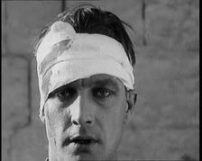 Scene from a Film: Male Actor Playing a Survivor from the Battle Being Questioned..., 1920s. Creator: British Pathe Ltd