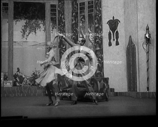 Scene from a Stage Show: Male and Female Civilian Dancing on a Stage in a Routine with..., 1929. Creator: British Pathe Ltd.