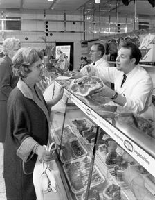 Scene inside a butcher's shop, Doncaster, South Yorkshire, 1965. Creator: Michael Walters