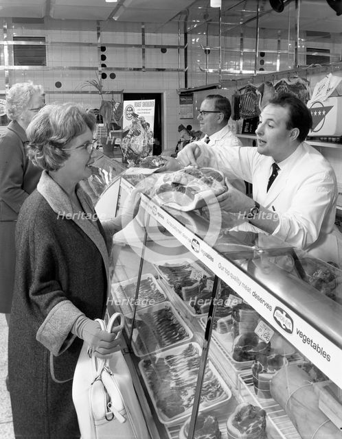 Scene inside a butcher's shop, Doncaster, South Yorkshire, 1965. Creator: Michael Walters.
