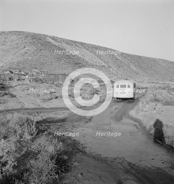 School bus starts up the flat 7:30 a.m. to collect children of new..., Malheur County, Oregon, 1939. Creator: Dorothea Lange.
