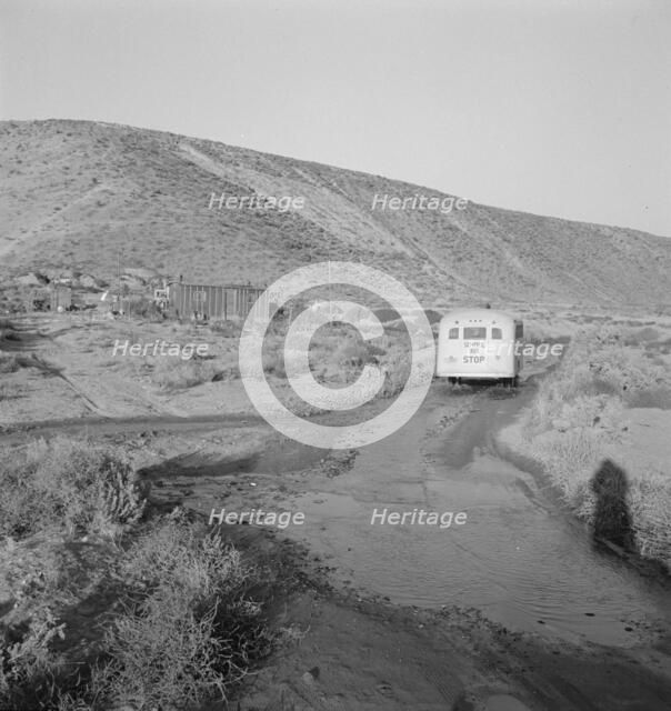 School bus starts up the flat 7:30 a.m. to collect children of new..., Malheur County, Oregon, 1939. Creator: Dorothea Lange.
