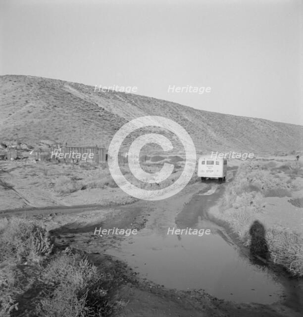 School bus starts up the flat 7:30 a.m. to collect..., Malheur County, Oregon, 1939. Creator: Dorothea Lange.