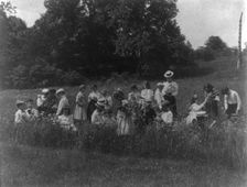 School children examining wild flowers on field trip - 1st Division, Washington, D.C..., (1899?). Creator: Frances Benjamin Johnston
