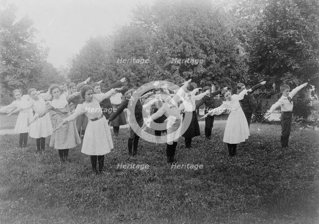 School children exercising on lawn, Washington, D.C., (1899?). Creator: Frances Benjamin Johnston.