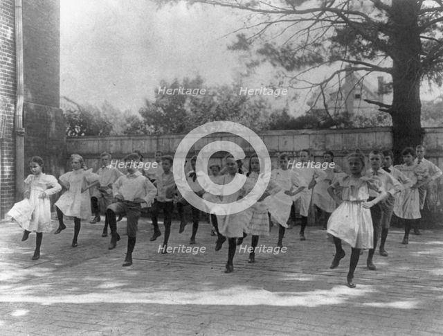 School children learning a dance in a school yard, Washington, D.C., (1899?). Creator: Frances Benjamin Johnston.