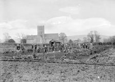 Schoolboys working in the school garden supervised by a teacher, Uffington, Oxfordshire, 1916. Artist: FW Ault