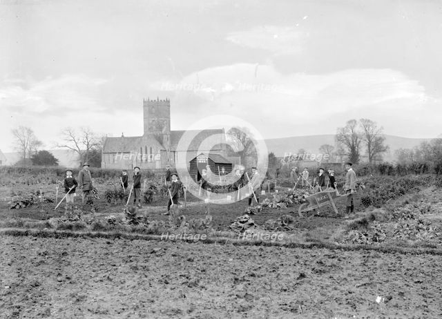 Schoolboys working in the school garden supervised by a teacher, Uffington, Oxfordshire, 1916. Artist: FW Ault