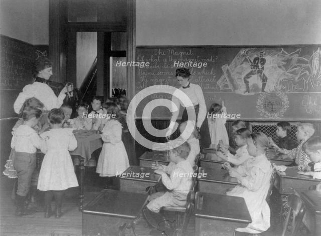 Science classroom scene - 7 or 8 year-olds studying the magnet, 8th Division, Washington DC, (1899?) Creator: Frances Benjamin Johnston.