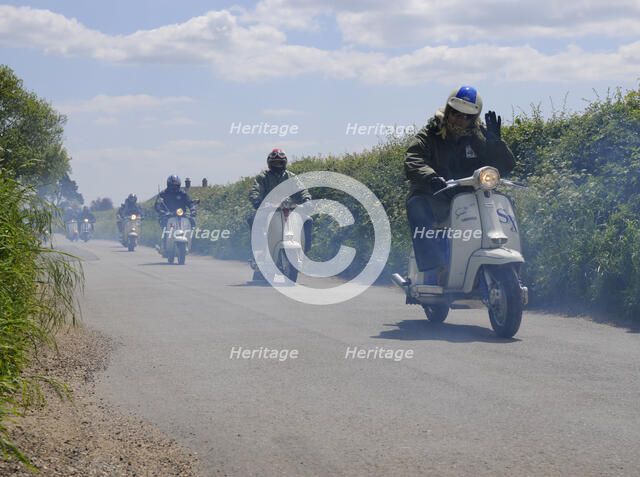 Scooters enjoying run on country lane. Artist: Unknown.