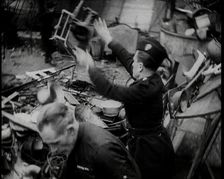 Scrap Metal Being Thrown into a Pile, 1936. Creator: British Pathe Ltd