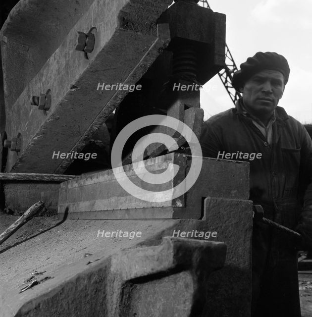 Scrapyard worker, Rotherham, South Yorkshire, 1963. Creator: Michael Walters.