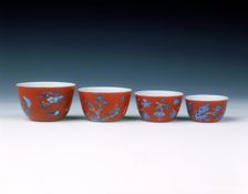Set of four graduated wine cups on coral ground, Qing dynasty, China, 1700-1722
