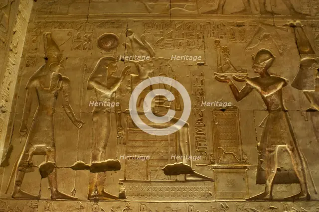 Seti I offering a statue of goddess Maat to gods Osiris..., Temple of Seti I, Abydos, Egypt (2003). Creator: LTL.