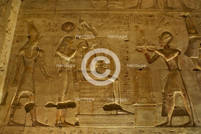 Seti I offering a statue of goddess Maat to gods Osiris..., Temple of Seti I, Abydos, Egypt (2003). Creator: LTL.