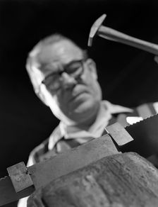 Setting the saw teeth on a hand saw blade, Sheffield, South Yorkshire, 1963. Creator: Michael Walters