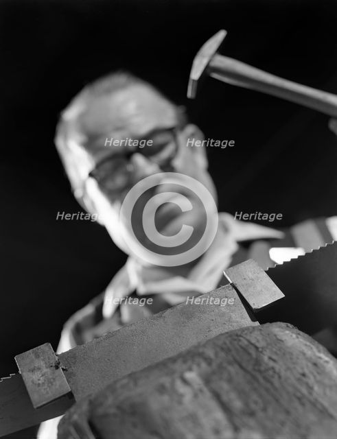 Setting the saw teeth on a hand saw blade, Sheffield, South Yorkshire, 1963. Creator: Michael Walters.
