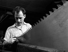 Setting the saw teeth a two metre saw blade, Sheffield, South Yorkshire, 1963. Creator: Michael Walters