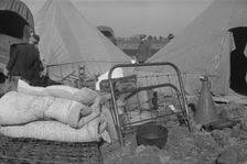 Setting up a tent in the camp for white flood refugees, Forrest City, Arkansas, 1937. Creator: Walker Evans