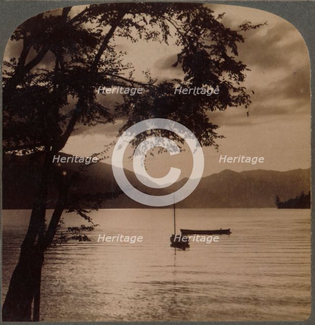 'Setting sun, over Lake Chuzenj, lying within its mountain walls, Japan', 1904.  Artist: Unknown.