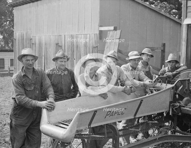Seven of the eight farmers shown with their coop...West Carlton, Yamhill County, Oregon, 1939. Creator: Dorothea Lange.