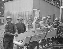 Seven of the eight farmers shown with their coop...West Carlton, Yamhill County, Oregon, 1939. Creator: Dorothea Lange